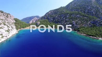 4K Aerial Clip Of Cove, Sea, Boats And Mountain free download